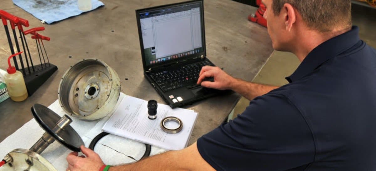 Centerline technician inspecting and diagnosing a disassembled machine tool spindle